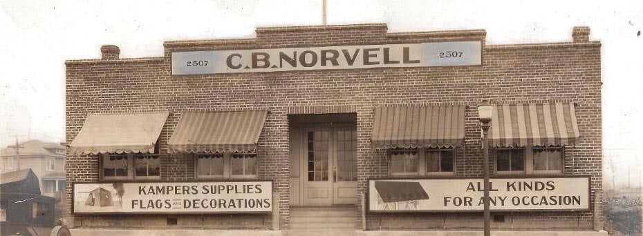 Historic picture of CB Norvell company building with different styles of fabric awnings Petersburg, VA