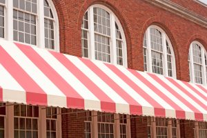 Red-and-white striped awning on brick business building
