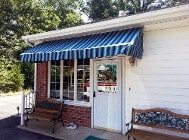 View of a beautiful blue awning with stripes on a home