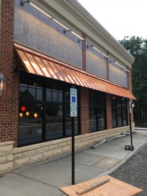Awning installed over a business' windows and sidewalk