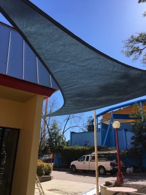 A shade-sail installed in front of a beautiful home